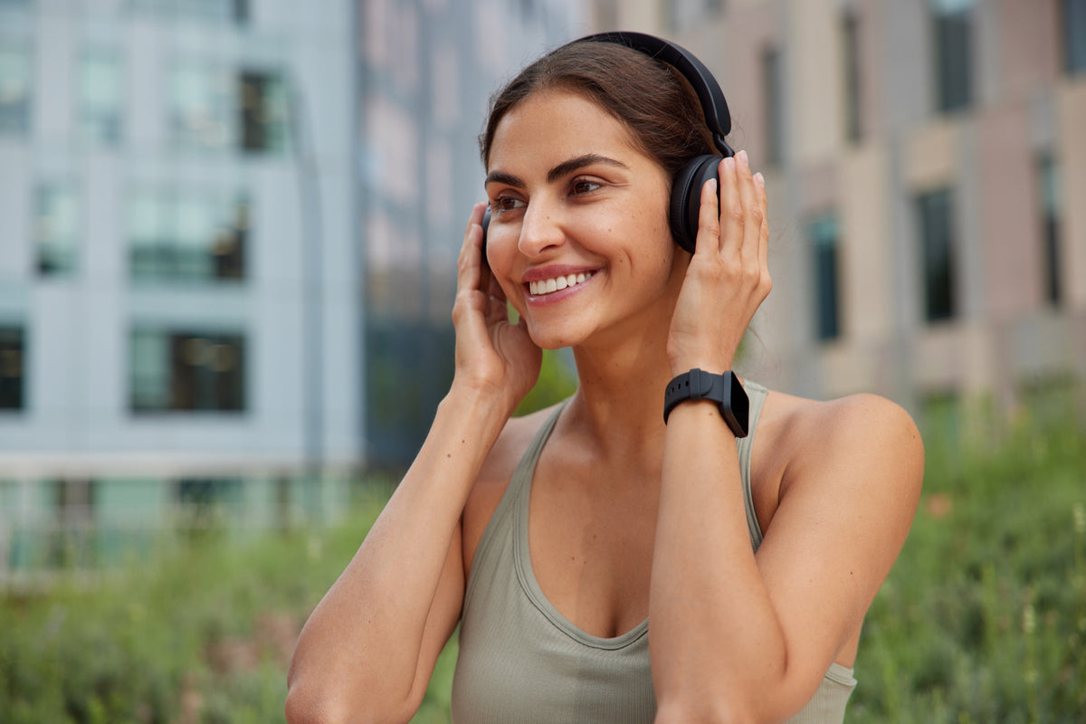 Woman enjoying music outdoors as part of her daily wellness routine